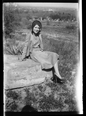 [Photograph of Young Woman Sitting on Rock]
