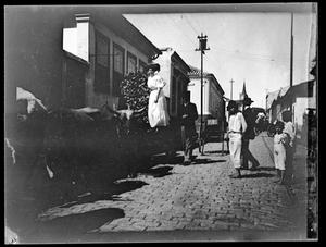 [Photograph of Cattle and People Along Street]