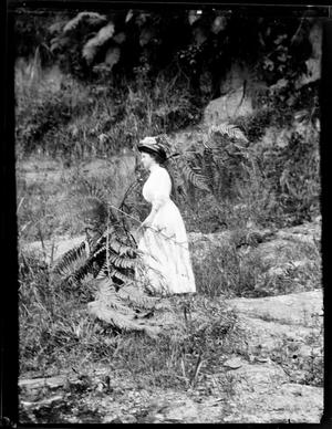 [Photograph of Young Woman on Rocky Hillside]