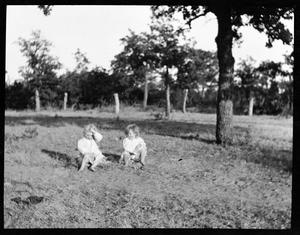 [Photograph of Two Children Sitting in Dirt]