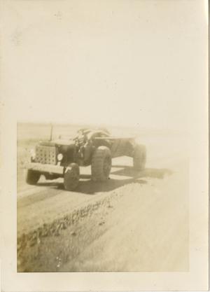 Primary view of object titled '[Man Driving Tractor and Towing Trailer]'.