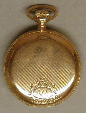 [Gold pocket watch with "JHPD" engraved on the front]