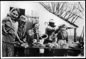 [Members of the Linke and Eben families making sausage]