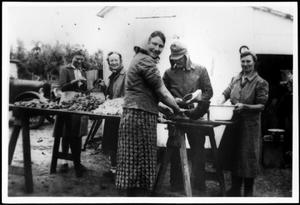 [Members of the Linke and Eben families making sausage]