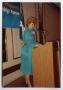 Photograph: [Photograph of Tracey Bright Behind Podium]