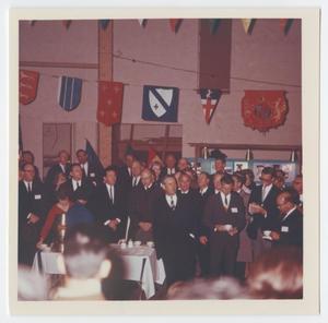 Primary view of object titled '[Photograph of Large Group Gathered Under Flags]'.