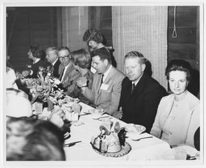 [Photograph of John Ben Shepperd and Group at Dinner]
