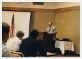 Thumbnail image of item number 1 in: '[Photograph of Dr. Duane M. Leach Speaking]'.