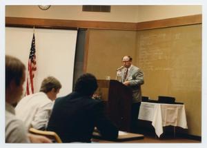 [Photograph of Dr. Duane M. Leach Speaking]