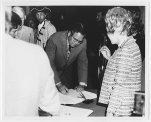 [Photograph of Governor Dolph Briscoe Signing Document]