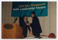 Primary view of [Photograph of Dan Morales and Richard Battle Shaking Hands]