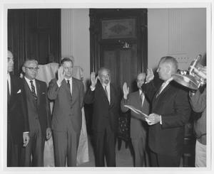 [Photograph of Group of People Taking Oath]