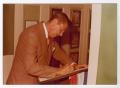 Photograph: [Photograph of Ronald Reagan Writing on Document]