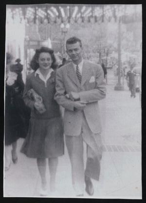 [Helen Snapp and a Young Man Walking Down a Street]