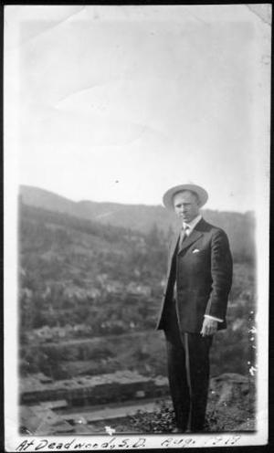 Primary view of object titled '[A man standing on a cliff overlooking a city]'.
