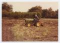 Photograph: [Photograph of Otto Haker Mowing His Lawn]