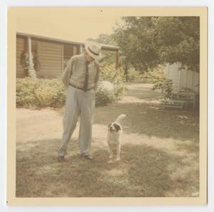 [Photograph of Lee Turney With Dog in Yard]