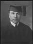 Photograph: [A young man wearing a graduation gown with cap and tassel]