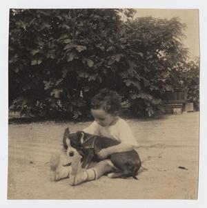 Primary view of object titled '[Photograph of a Child Sitting and Holding a Dog]'.