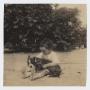 Thumbnail image of item number 1 in: '[Photograph of a Child Sitting and Holding a Dog]'.