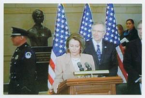Primary view of object titled '[Photograph of Nancy Pelosi Speaking at a Podium With a Microphone]'.
