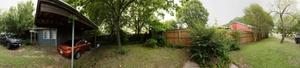 Primary view of object titled 'Panoramic image of the carport and front yard of a home in Denton, Texas.'.