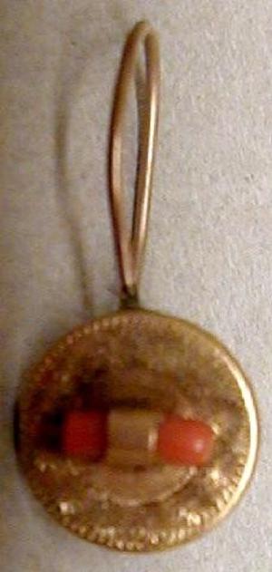 [One gold earring that has a gold round medallion]