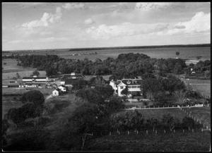 Primary view of object titled '[Aerial photograph of the George Ranch house and ranch site surrounded by trees]'.