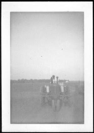 [A man on a tractor in a field on the George Ranch]
