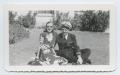 Photograph: [Man and Woman Sitting on Lawn]