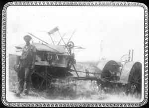 [Man leaning against a rice combine or cutter at the George Ranch]