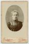 Photograph: [Photograph of a Woman Wearing Dark Clothing]