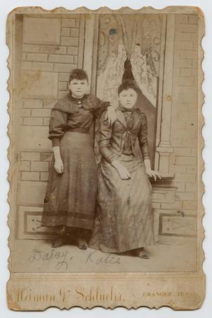 [Photograph of Daisy and Katie Pennington in Front of a Window]