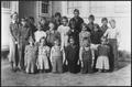 Photograph: [Twenty students and one teacher in front of the George School]