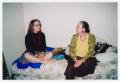 Photograph: [Two Women Sitting on Bed]
