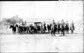 Postcard: [Ten men in uniform, mounted on dark horses]