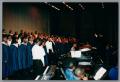 Thumbnail image of item number 1 in: '[Choir ensemble looking at conductor]'.