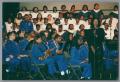 Photograph: [Tanya Blount on stage with choir and band ensemble]