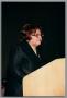 Photograph: [Woman speaking behind podium]
