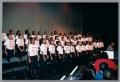 Photograph: [Young choir members standing on stage]