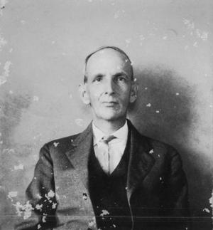 [Unidentified older man wearing a three piece suit and a light colored tie]