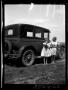 Photograph: [Portrait of Two Girls Beside an Automobile]