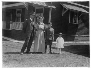 [Unidentified Family Standing in Front of House]