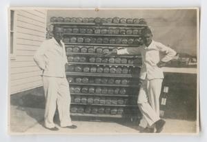 [Photograph of Two Bakers and a Rack of Bread]