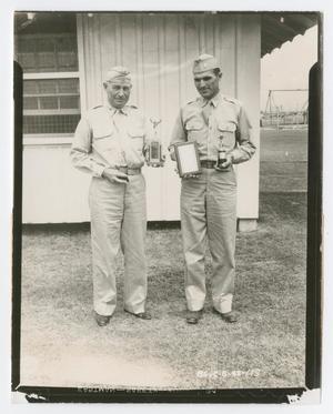 [Photograph of Two Officers Holding Trophies]