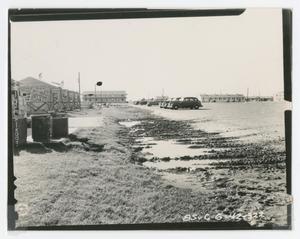 [Photograph of Cars Parked Next to Piles of Mud]