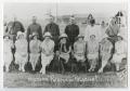 Photograph: [Photograph of Uniformed Men Behind Nine Women]