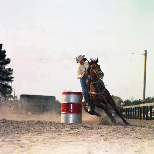 Photo of Woman barrel racing. Item from the Horse Country USA Archive.